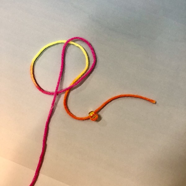 String with a pony bead on it