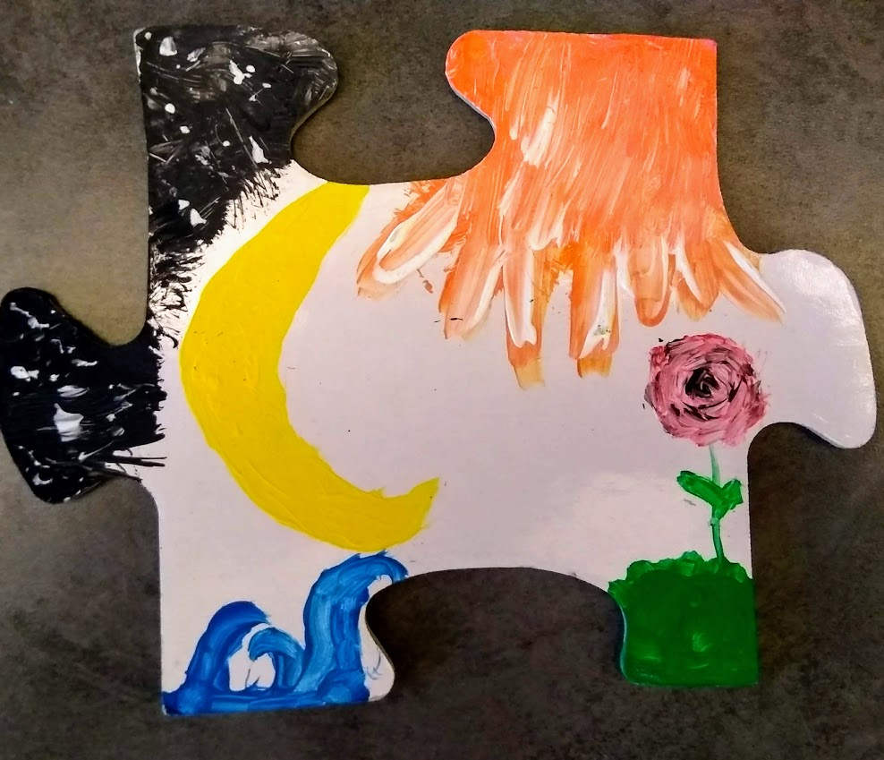 puzzle piece decorated with tempera paint