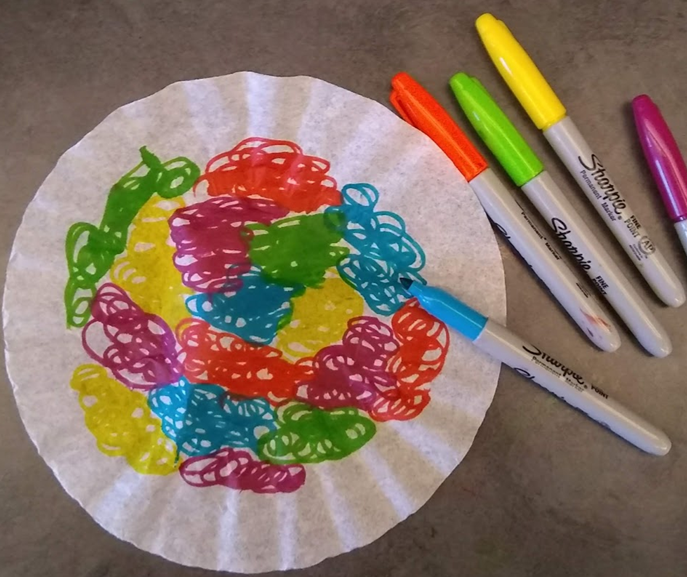 Color the coffee filter with markers
