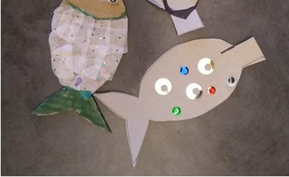 cardboard fish decorated with tissue paper and sequins