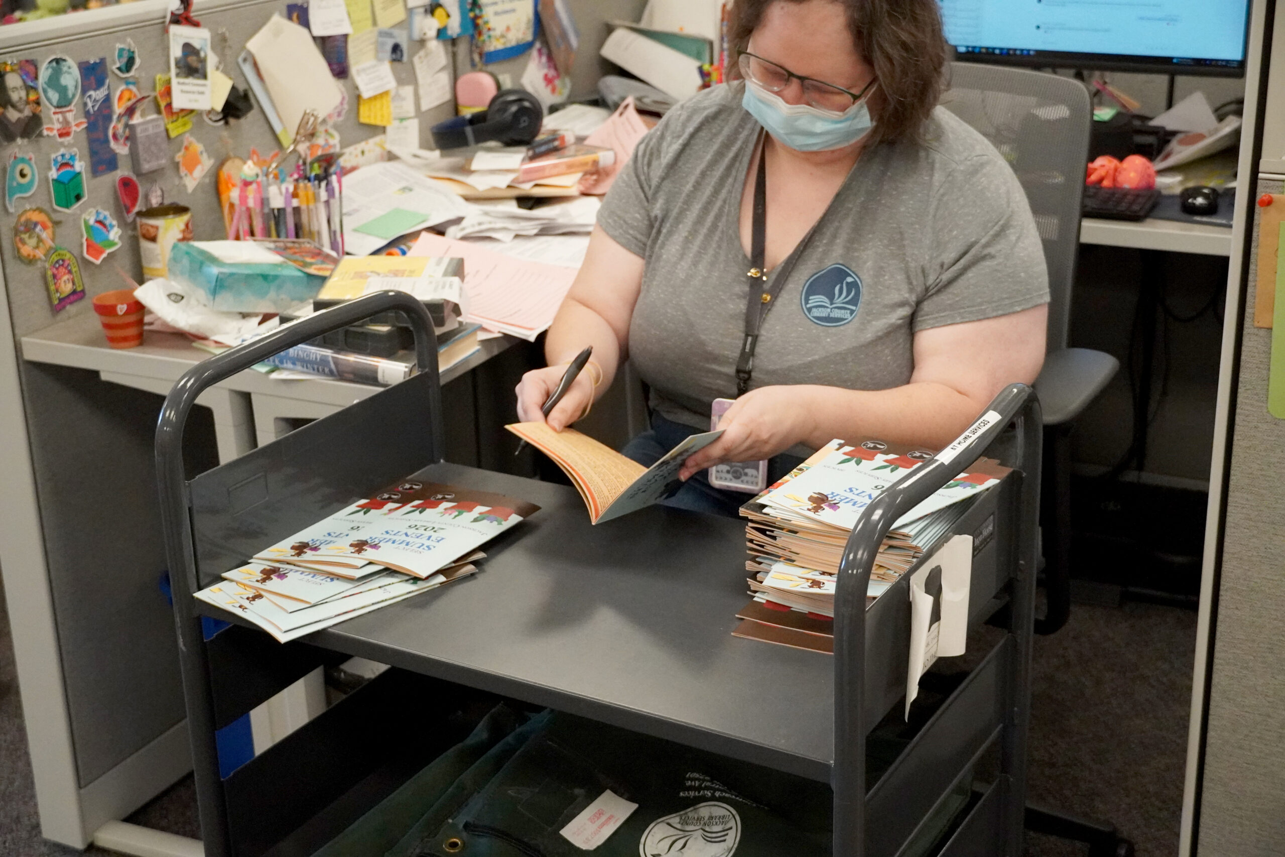 Library staff selecting materials for an At Home Services patron