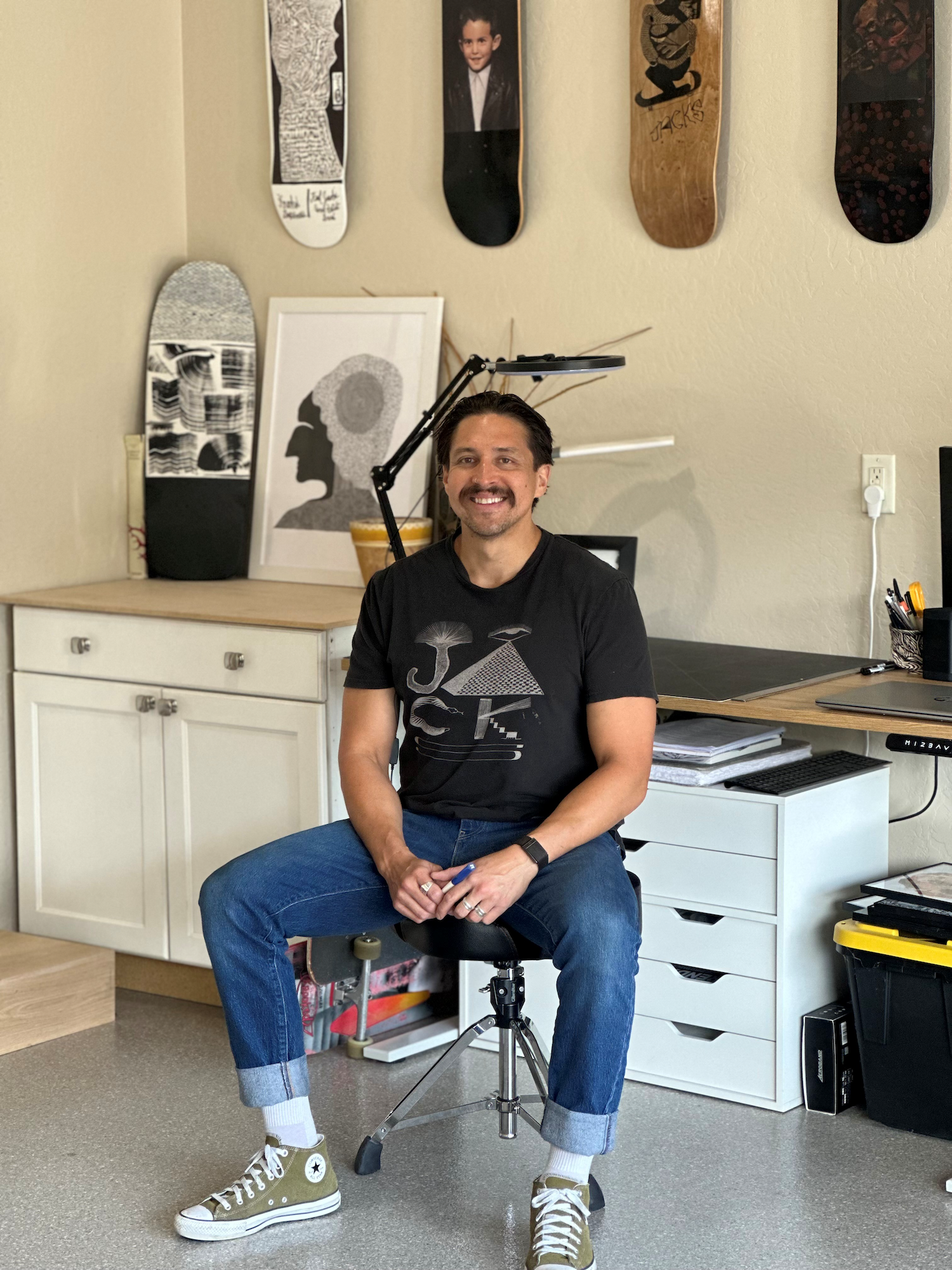 Artist Adriano Martinez seated in his studio
